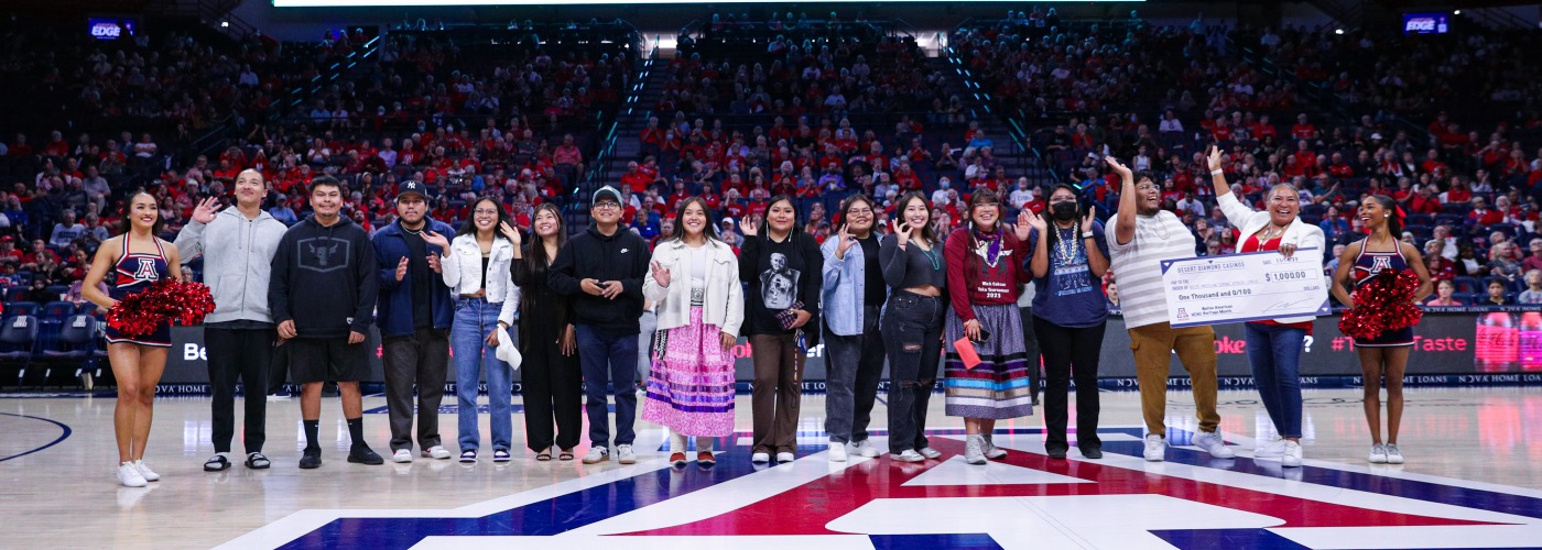 Group photo of NASA students during the Native American Heritage Month basketball game at McKale Center