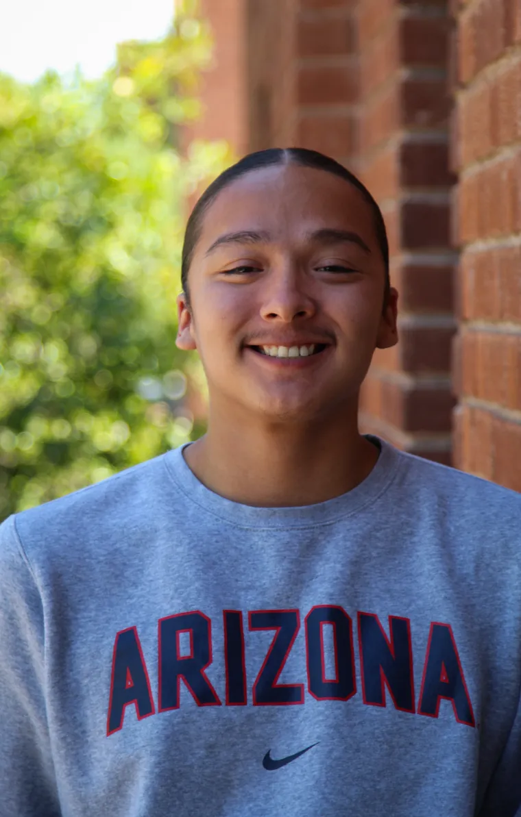 A headshot image of student staff Nicolas Littleman with a brick building in the background