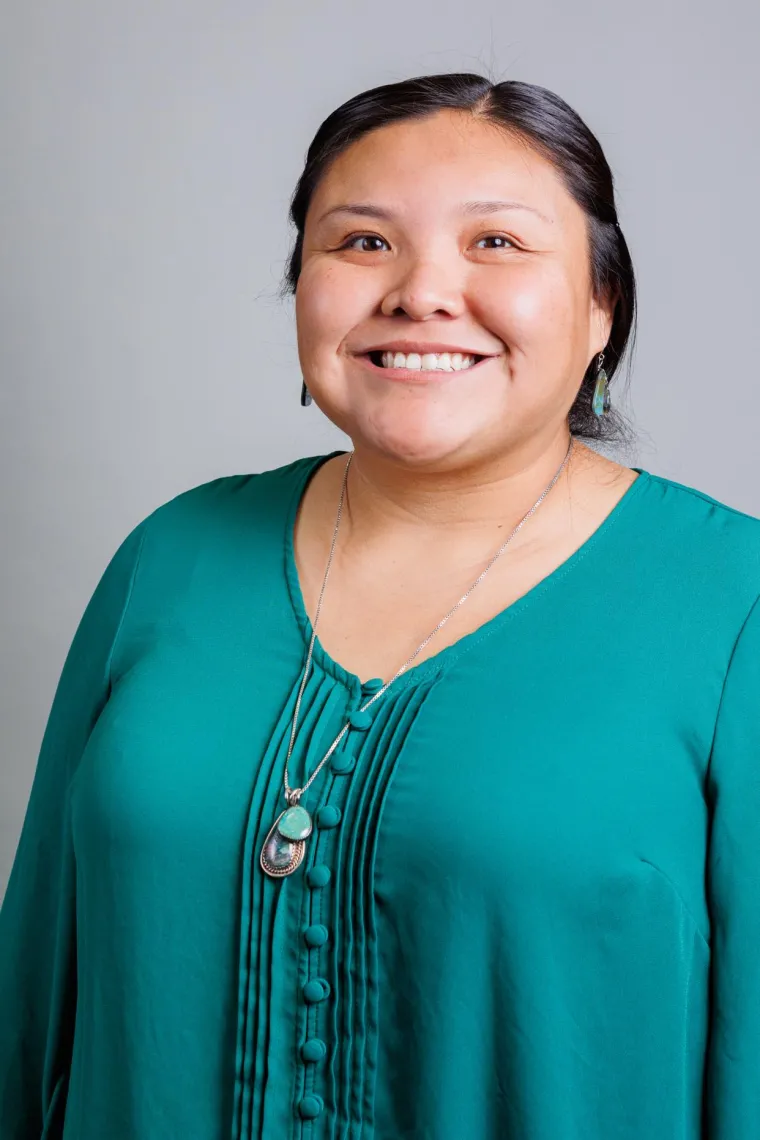 Professional headshot of Myrhea (NASA Coordinator) standing against a gray backdrop